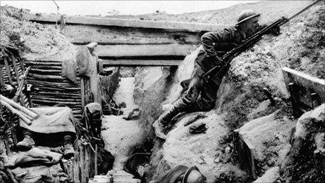 A British Grenadier Guardsman keeps watch in a captured German trench near La Boisselle in 1916 as his comrades sleep during the Battle of the Somme