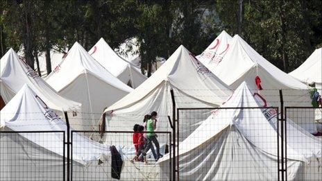 Children walk beside tents in a refugee camp in the Turkish town of Yayladagi in Hatay province, near the Syrian border, on Thursday