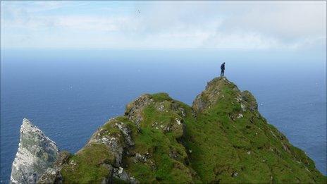 Survey team member on Mullach an Eilein, the highest point on Boreray. Image: RCAHMS