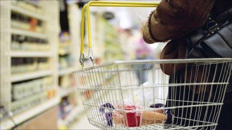 Shopping basket with carrots in it