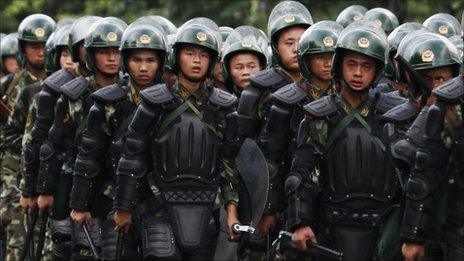 Riot police patrol on a street in the township of Xintang in Zengcheng near the southern Chinese city of Guangzhou June 13, 2011