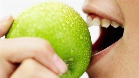 Woman eating an apple