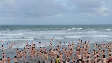 Mass skinny dip at Rhossili on Gower