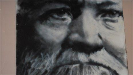 A spray paint picture of Andrew Carnegie which hangs in Swinton library