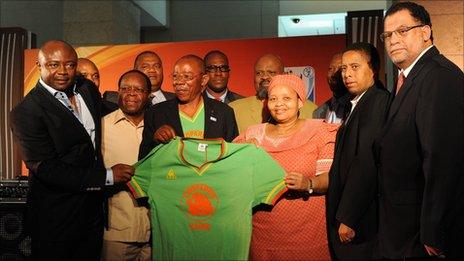 Abedi Pele (far left), Mulamba Ndaye (holding shirt) and Danny Jordaan (far right)