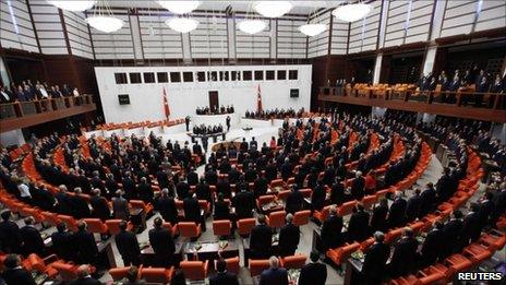 Turkish MPs stand for the national anthem during the swearing-in ceremony in the Turkish parliament in Ankara, 28 June