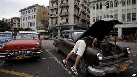 A man checks his old car in Havana on 1 July 2011