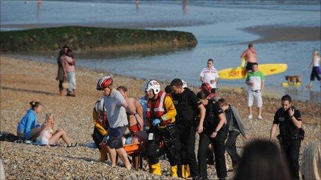 Rescuers carry the man from the sea