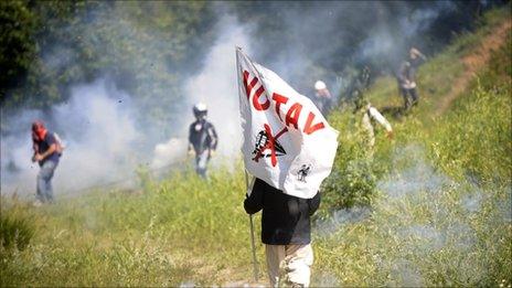 A protester holds a flag reading "No TAV" during a protest against the construction of a high-speed train line, the TAV, on 3 July.