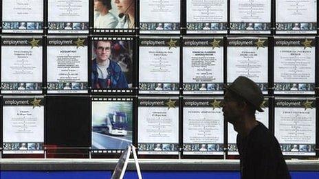 Man walks past vacancies signs at a recruitment office in Bristol