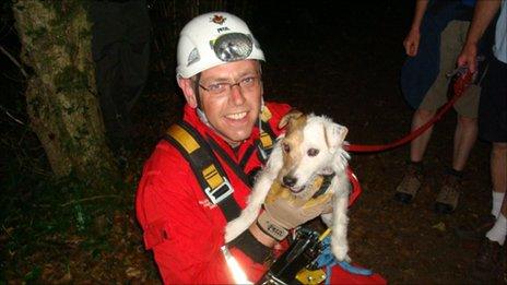 Trixie the Jack Russell dog with a member of the Gloucestershire Fire and Rescue service