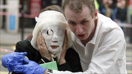 Paul Dadge helps Davinia Turrell (married name now Davinia Douglass) who is wearing a protective gauze mask, following an explosion at Edgware Road Tube Station on 7/7.