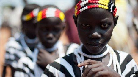 Young Sudanese girls in traditional dress participate in a march organised by the Sudan People's Liberation Movement in Juba on 5 July