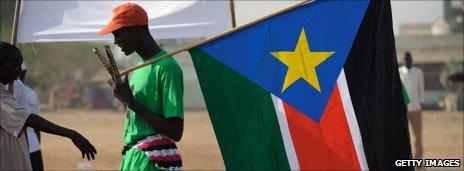 A man holds the new flag of South Sudan