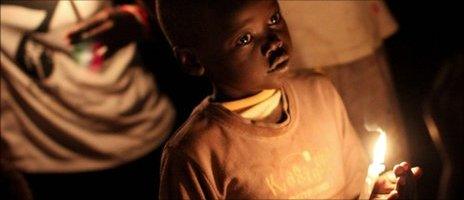 A South Sudanese boy holds a candles at midnight on 9 July 2011 to mark the day that South Sudan became independent