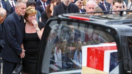 Family members beside the hearse