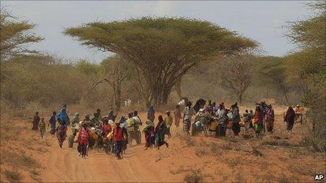 Somalis walk down the main road leading to the refugee camps around Dadaab, Kenya (13 July 2011)