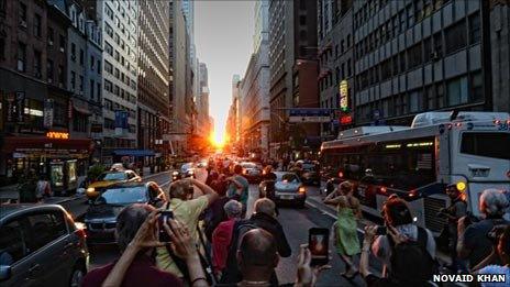 Crowds shoot down a crowded street