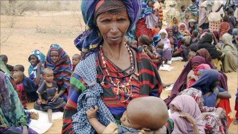 Refugees and children wait to go to a refugee camp in the Ethiopian town of Dolo Ado