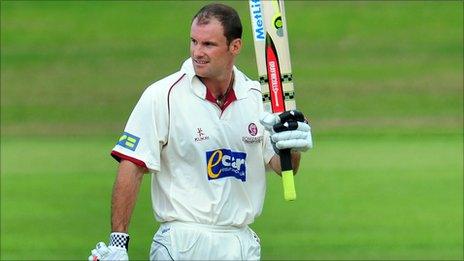 Andrew Strauss raises his bat after reaching his century