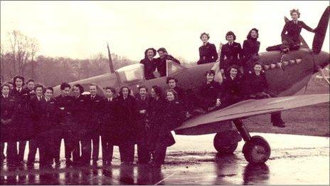 A group of women posing with a spitfire at Hamble Airfield in Southampton