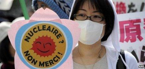 A protester holds a placard during a rally demanding the stop of the Hamaoka nuclear power plant in Tokyo on April 10, 2011