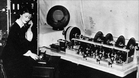 Ethel Jane Cain, first voice of the Speaking Clock in 1936, with the glass discs that carried the recordings she made