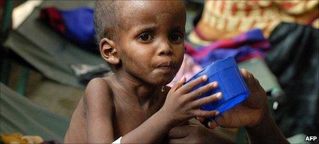 A displaced Somali mother attends her malnourished child at southern Mogadishu's Banadir hospital on 19 July 2011