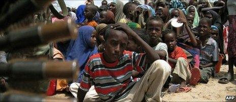 Somali displaced people wait for a food-aid distribution at a camp in southern Mogadishu on 21 July 2011