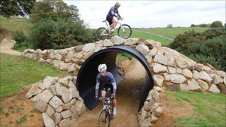 Two riders tackle the tunnel and overpass section of the Olympic mountain bike venue at Hadleigh Farm
