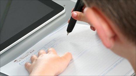 Boy writing with digital pen. Pic: Bible Society/Mark Cameron