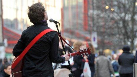 A busker performs on a street