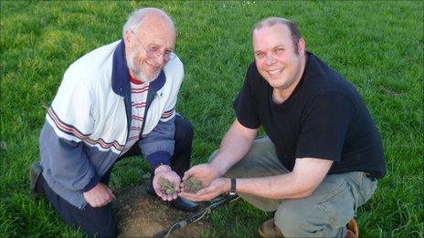 Adrian Simmons (r) and his father Reg with some of the coins