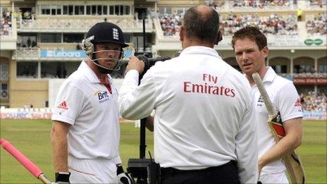 Ian Bell (left) talks to umpire Tim Robinson as Eoin Morgan watches on