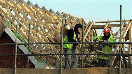 Builders building a roof