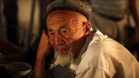 An ethnic Uighur man sits at a local market in Kashgar, Xinjiang