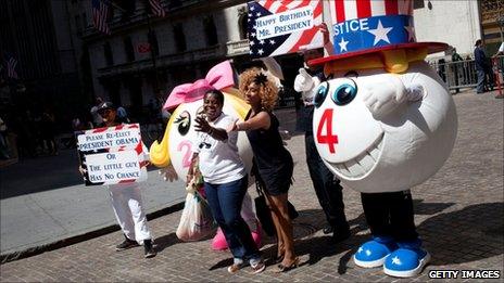 Members of Americans 4 Justice, an activist group supportive of US President Barack Obama, sing "Happy Birthday" in front of the New York Stock Exchange on 3 August 2011