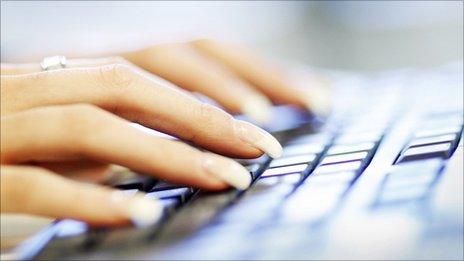 Woman typing on computer