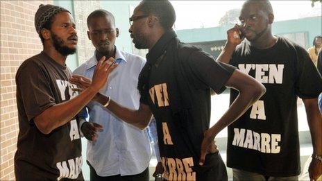 Thiat (L) speaks with members of the Enough is Enough movement (27 June)