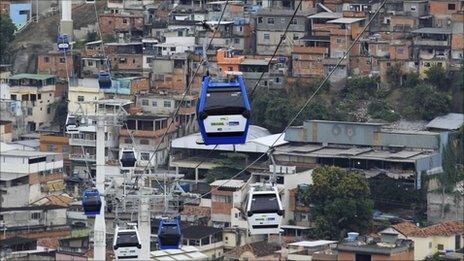 Cable cars are seen over Alemao slum after Brazil's President Dilma Rousseff opened the new transportation system in Rio de Janeiro 7 July 2011