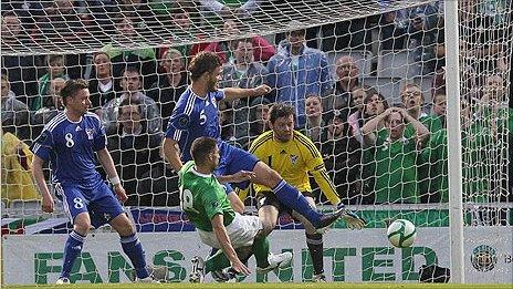 Aaron Hughes sends his shot in off the post to put Northern Ireland into the lead against the Faroe Islands