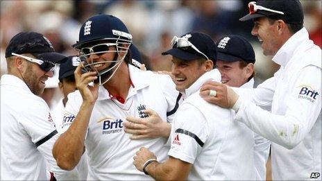 England celebrate after Alastair Cook takes a superb catch to end India's innings