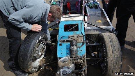 The team examines the damaged suspension