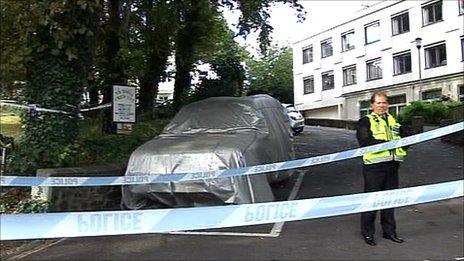 A police officer stands guard at the crime scene