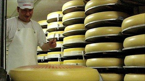 Christoph Raz uses a hammer to test if traditional Emmentaler holes are forming