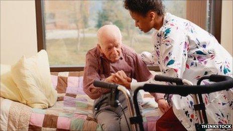 Nurse helping elderly man to stand