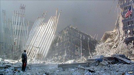 A man stands among the rubble of the World Trade Center after the attacks on 11 September 2011