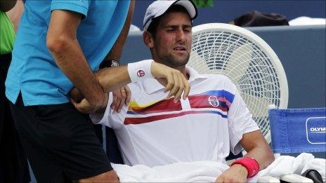 Novak Djokovic receives treatment to his shoulder