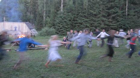 People dance around a bonfire in Estonia