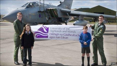 The Tornado crew and local schoolchildren with a UHI banner